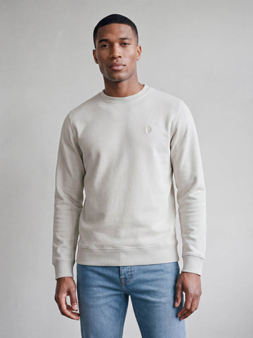 Man wearing stone LUKE 1977 Leo lux touch sweatshirt with jeans, front view