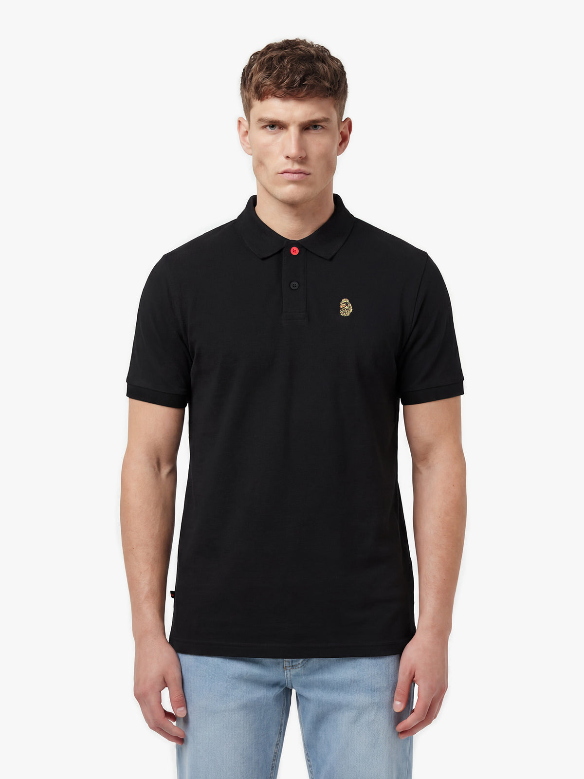 Man wearing black LUKE 1977 New Mead cotton piqué polo shirt with jeans, front view