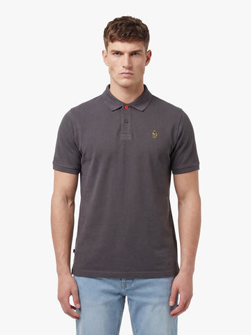 Man wearing charcoal LUKE 1977 New Mead cotton piqué polo shirt with jeans, front view