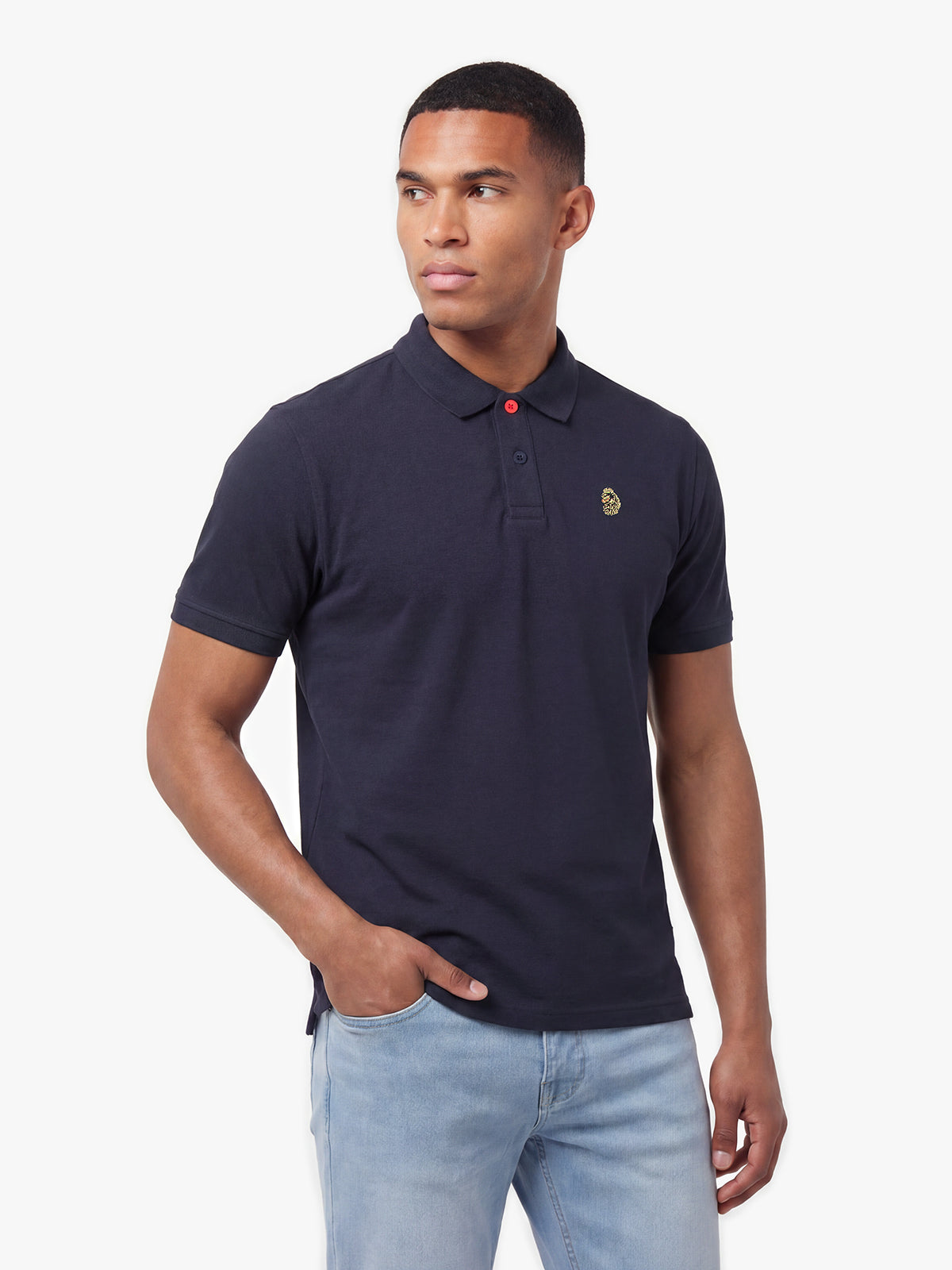 Side view of man wearing navy LUKE 1977 New Mead polo shirt