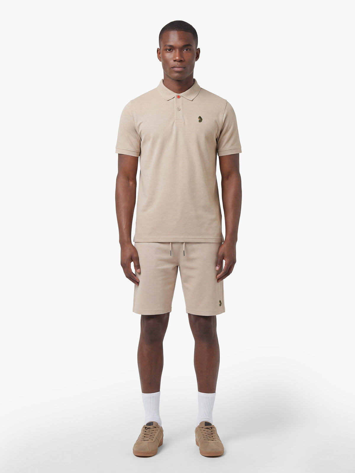 Men's beige short set with short-sleeve shirt and drawstring shorts, worn by model.