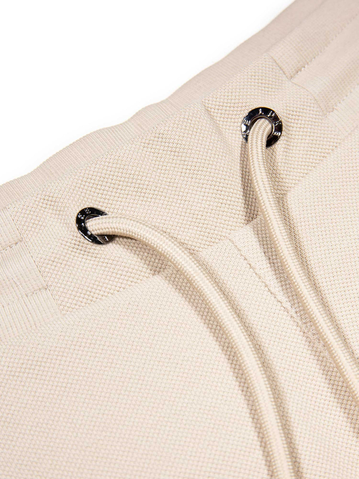 Men's beige short set with short-sleeve shirt and drawstring shorts, detail view.