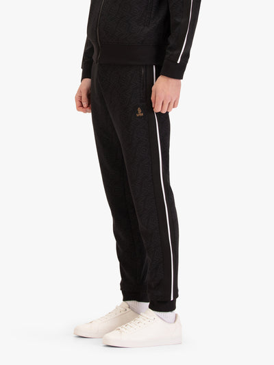 Men's black joggers with drawstring waistband, worn by a model, side view