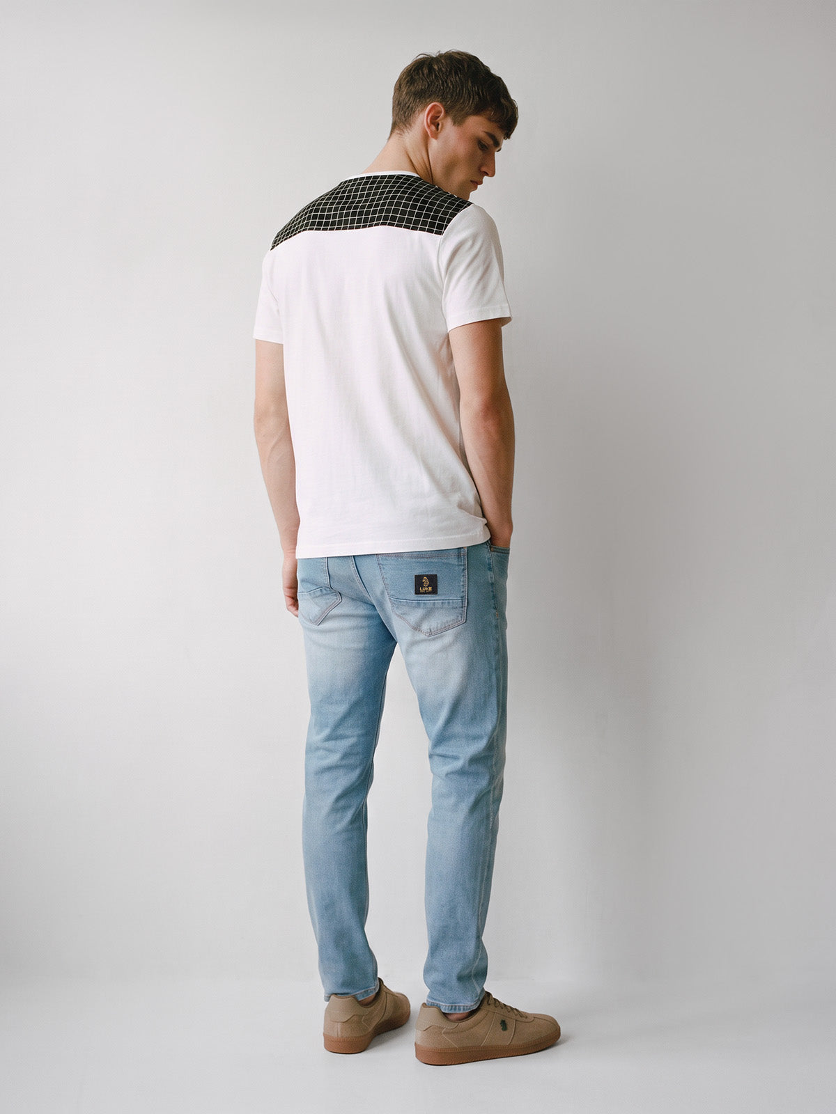 Back view of white LUKE 1977 Burr t-shirt with contrast check yoke, worn with jeans