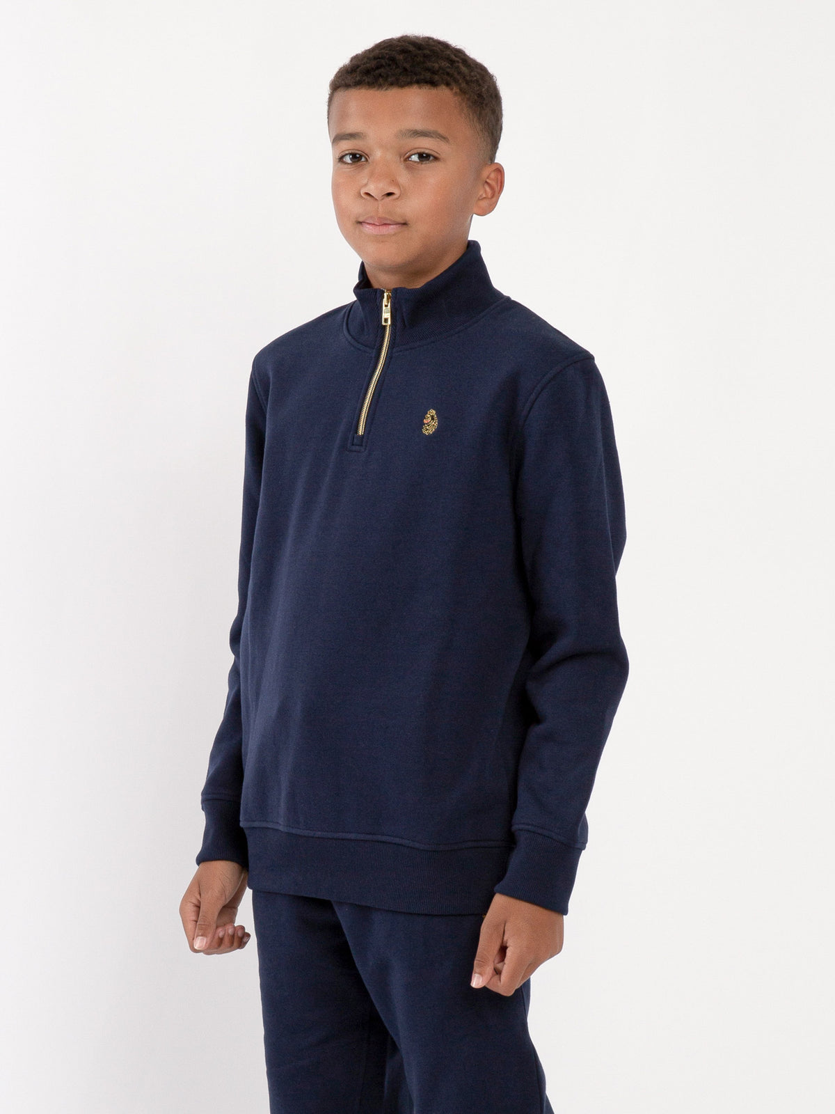 Boy's sweatshirt with quarter-zip and fleece worn by model, side view